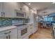 Bright kitchen with white cabinets and dining area, creating a cozy atmosphere at 4307 Gulf Dr # 103, Holmes Beach, FL 34217