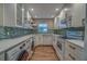 Modern kitchen with white cabinets, marble countertops, and stainless steel appliances at 4307 Gulf Dr # 103, Holmes Beach, FL 34217