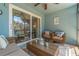 Relaxing screened lanai with wicker furniture and glass sliding doors at 4307 Gulf Dr # 103, Holmes Beach, FL 34217