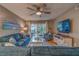 Comfortable living room with modern decor, a ceiling fan, and access to the outdoors at 4307 Gulf Dr # 103, Holmes Beach, FL 34217