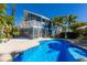 Sparkling blue pool with a unique freeform design, adjacent to the house at 4820 Higel Ave, Sarasota, FL 34242