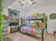 Tropical-themed bedroom with a bunk bed and lush green wall at 5558 Palmer Cir # 101, Bradenton, FL 34211