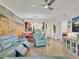 Open living space with sectional sofa, and beach mural at 5558 Palmer Cir # 101, Bradenton, FL 34211