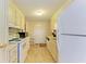 White kitchen cabinets and appliances in a galley-style kitchen at 5619 Bayshore Rd # 365, Palmetto, FL 34221