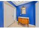 Bright entryway with blue walls, ornate mirror, and console table at 6482 Water Crest Way # 204, Lakewood Ranch, FL 34202