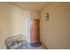 Condo entryway with an orange door and a metal bench at 6482 Water Crest Way # 204, Lakewood Ranch, FL 34202