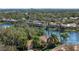 Waterfront homes with lush tropical landscaping and tile roofs, aerial view at 6922 Langley Pl, University Park, FL 34201