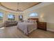 Luxurious main bedroom with a king-size bed and water views at 6922 Langley Pl, University Park, FL 34201