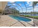 Screened pool and patio with lake view at 6922 Langley Pl, University Park, FL 34201