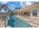 Long, rectangular pool with spa and screened enclosure at 6922 Langley Pl, University Park, FL 34201