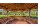 Wooden gazebo with seating, offering scenic views of the neighborhood at 710 Shadow Bay Way, Osprey, FL 34229