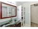 Modern bathroom with glass sink, large mirror and ample storage at 719 Wood Ln, Sarasota, FL 34237