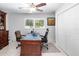 Home office with large desk, two chairs, and built-in cabinetry at 719 Wood Ln, Sarasota, FL 34237