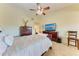 Main bedroom with king-size bed and separate sitting area at 7829 Pine Trace Dr, Sarasota, FL 34243