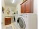Convenient laundry room with washer, dryer, and wood cabinets at 7830 34Th W Ave # 102, Bradenton, FL 34209