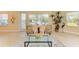 Bright living room with large windows, comfortable seating, and a stylish glass coffee table at 7830 34Th W Ave # 102, Bradenton, FL 34209