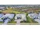 Aerial view of a house in a community with other houses and a conservation area at 7940 Redonda Loop, Bradenton, FL 34202