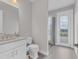 Modern bathroom with white vanity, toilet and a glass-enclosed shower at 7940 Redonda Loop, Bradenton, FL 34202