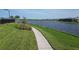 A paved walkway winds along a lake, offering scenic community views at 7940 Redonda Loop, Bradenton, FL 34202