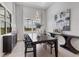Elegant dining room featuring a dark wood table, statement art, and natural light at 7940 Redonda Loop, Bradenton, FL 34202