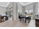 Bright dining room with large table, modern lighting, and access to the kitchen at 7940 Redonda Loop, Bradenton, FL 34202