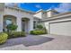 Front view of a house with a three car garage and a paver driveway at 7940 Redonda Loop, Bradenton, FL 34202