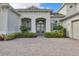 Double door entry to a house with lush landscaping at 7940 Redonda Loop, Bradenton, FL 34202