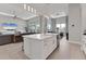 Modern kitchen with white cabinets, large island, and stainless steel appliances at 7940 Redonda Loop, Bradenton, FL 34202