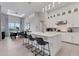 Open concept kitchen with white cabinets, island with seating, and dining area at 7940 Redonda Loop, Bradenton, FL 34202