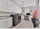 Bright laundry room with white cabinets, washer, dryer, and built-in workspace at 7940 Redonda Loop, Bradenton, FL 34202