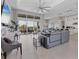 Open-concept living area with sectional sofa, pool view, and kitchen access at 7940 Redonda Loop, Bradenton, FL 34202
