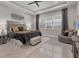Spacious main bedroom with a large bed, plush seating, and plenty of natural light at 7940 Redonda Loop, Bradenton, FL 34202