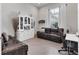 Home office with leather seating, built-in shelving, and ample natural light at 7940 Redonda Loop, Bradenton, FL 34202