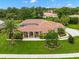 Single-Gathering home with tile roof, landscaping, and a palm tree in front at 8356 Mareva Ln, Sarasota, FL 34241