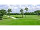 Picturesque golf course with palm trees and cart path at 8356 Mareva Ln, Sarasota, FL 34241