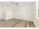 Bright bedroom with ceiling fan and wood-look flooring at 8405 Dolomite Ave, North Port, FL 34287