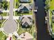 Aerial view of waterfront home with private dock and circular driveway at 8661 Quinn Ct, North Port, FL 34287