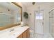 Bathroom with a vanity, toilet, shower, and access to backyard at 8661 Quinn Ct, North Port, FL 34287