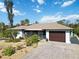 Single-story home with attached garage and well-maintained yard at 9025 Hilolo Ln, Venice, FL 34293