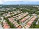 Beautiful aerial view of a residential community with lush landscaping, ponds, and tile roofs at 9143 Willow Brook Dr, Sarasota, FL 34238