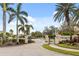 Elegant gated entrance to the Willowbrook community with lush landscaping and palm trees at 9143 Willow Brook Dr, Sarasota, FL 34238