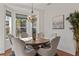 Elegant dining room featuring a round table, chandelier, and hardwood floors at 9822 Discovery Ter, Bradenton, FL 34212