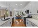 Bright kitchen featuring white cabinets, hardwood floors, and an island with seating at 9822 Discovery Ter, Bradenton, FL 34212