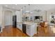 Open kitchen boasting white cabinetry, quartz countertops, and a breakfast bar at 9822 Discovery Ter, Bradenton, FL 34212