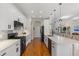 Modern kitchen with white cabinets, black appliances, and hardwood floors at 9822 Discovery Ter, Bradenton, FL 34212