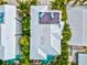 Overhead view of a home with a rooftop deck and surrounding tropical foliage at 106 7Th S St, Bradenton Beach, FL 34217