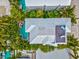 Aerial view of a home with private pool, deck, and lush landscaping at 106 7Th S St, Bradenton Beach, FL 34217