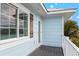 Private balcony with light blue siding and wood flooring at 106 7Th S St, Bradenton Beach, FL 34217