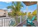 Relaxing balcony with teal adirondack chairs and tropical views at 106 7Th S St, Bradenton Beach, FL 34217