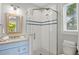 Bathroom with a walk-in shower and light blue vanity at 106 7Th S St, Bradenton Beach, FL 34217
